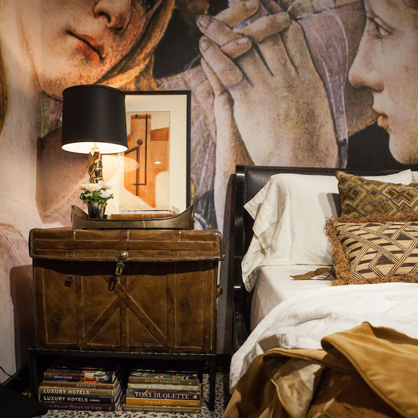 image of a bed with a large painting on the wall