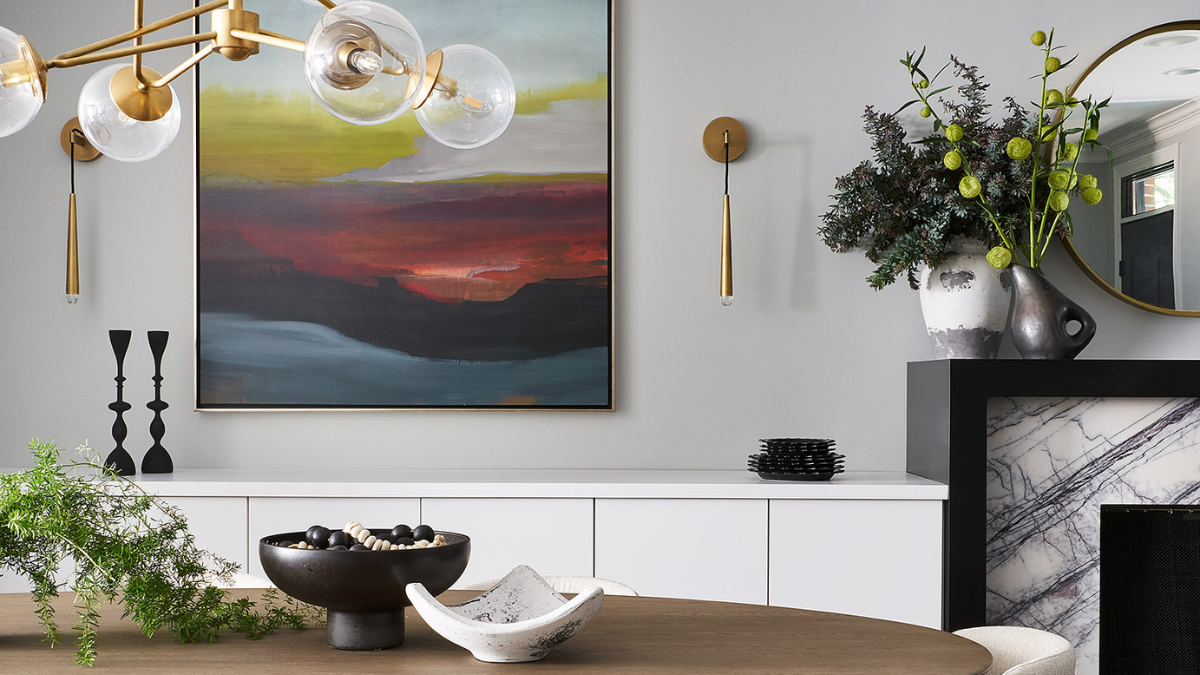 A modern dining room with a large abstract painting hanging above a wooden table.